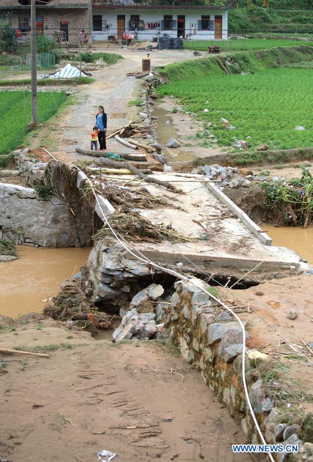 The only bridge of Huamugen Village is seen damaged in floods at Shuangfeng Town in Bobai County, south China&apos;s Guangxi Zhuang Autonomous Region, May 1, 2013. Floods and landslides triggered by heavy rain have claimed five lives while affecting more than 200,000 people in Guangxi. 