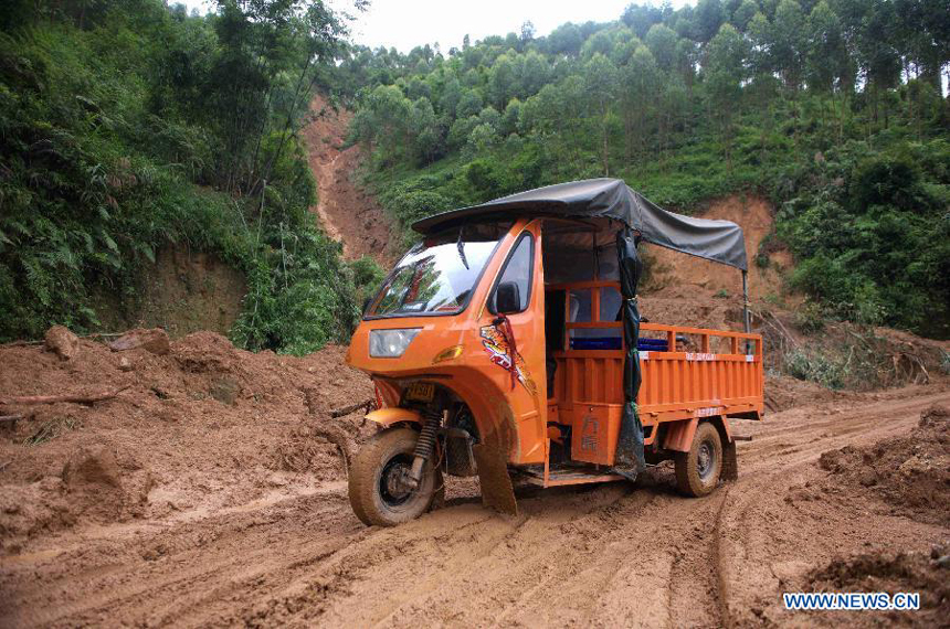 A tricycle sloshes on a road after a mud-rock flow in Bobai County, south China&apos;s Guangxi Zhuang Autonomous Region, May 1, 2013. Floods and landslides triggered by heavy rain have claimed five lives while affecting more than 200,000 people in Guangxi. 