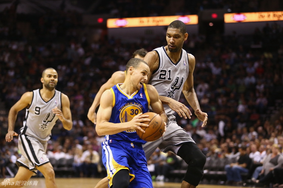 Stephen Curry drives in against Duncan.