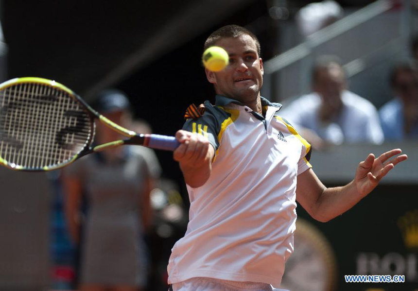 Mikhail Youzhny of Russia returns the ball during his men&apos;s 3rd round match against Rafael Nadal of Spain in the Madrid Tennis Open in Madrid, Spain, on May 9, 2013. Mikhail Youzhny lost 0-2. 