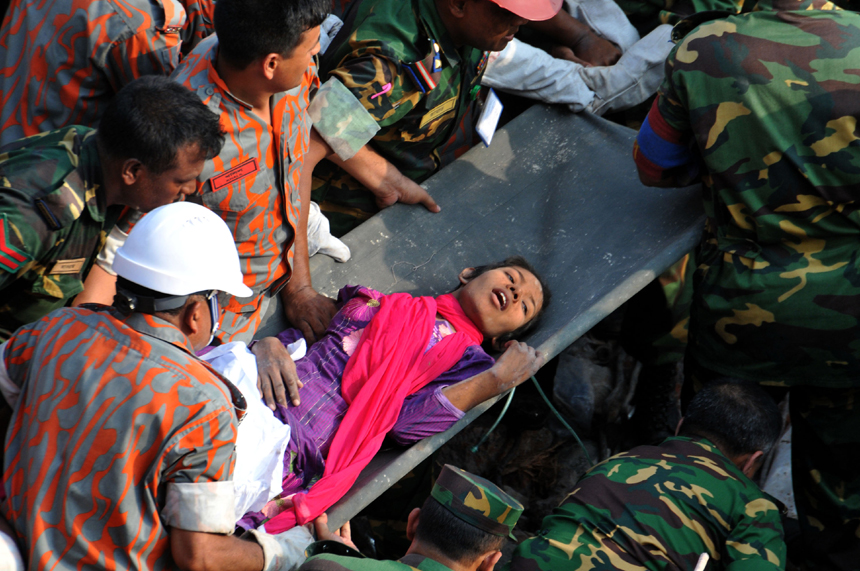 Rescuers help a female garment worker who survived the collapse of the eight-storey Rana Plaza building in Savar on the outskirts of Dhaka, Bangladesh, May 10, 2013. Rescuers on Friday evening found a garment worker named Reshmi who is still alive from piles of rubble of the building, 17 days after the collapse, the country&apos;s worst industrial disaster.