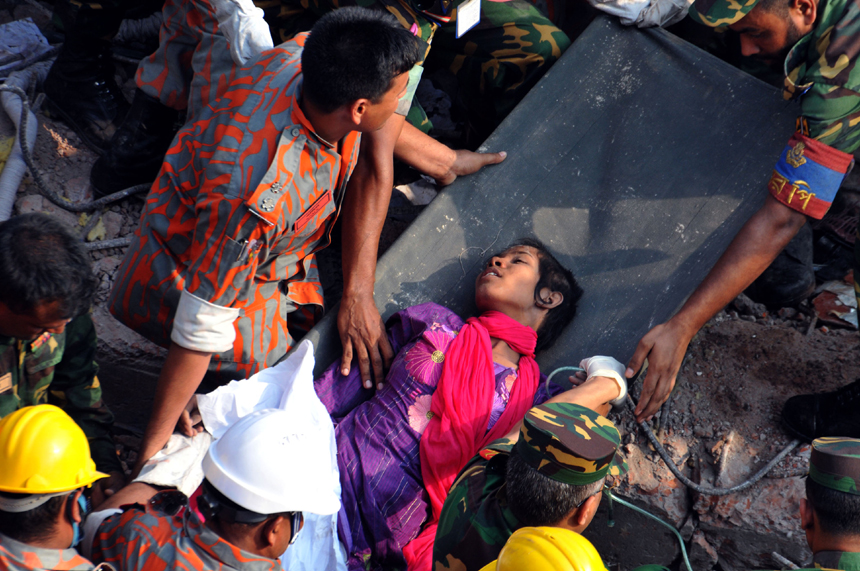 Rescuers help a female garment worker who survived the collapse of the eight-storey Rana Plaza building in Savar on the outskirts of Dhaka, Bangladesh, May 10, 2013. Rescuers on Friday evening found a garment worker named Reshmi who is still alive from piles of rubble of the building, 17 days after the collapse, the country&apos;s worst industrial disaster.