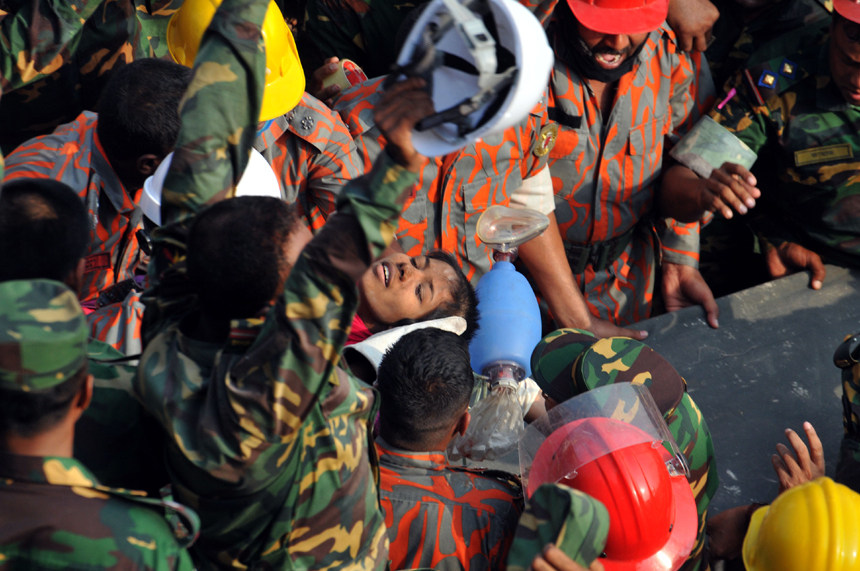 Rescuers help a female garment worker who survived the collapse of the eight-storey Rana Plaza building in Savar on the outskirts of Dhaka, Bangladesh, May 10, 2013. Rescuers on Friday evening found a garment worker named Reshmi who is still alive from piles of rubble of the building, 17 days after the collapse, the country&apos;s worst industrial disaster. 