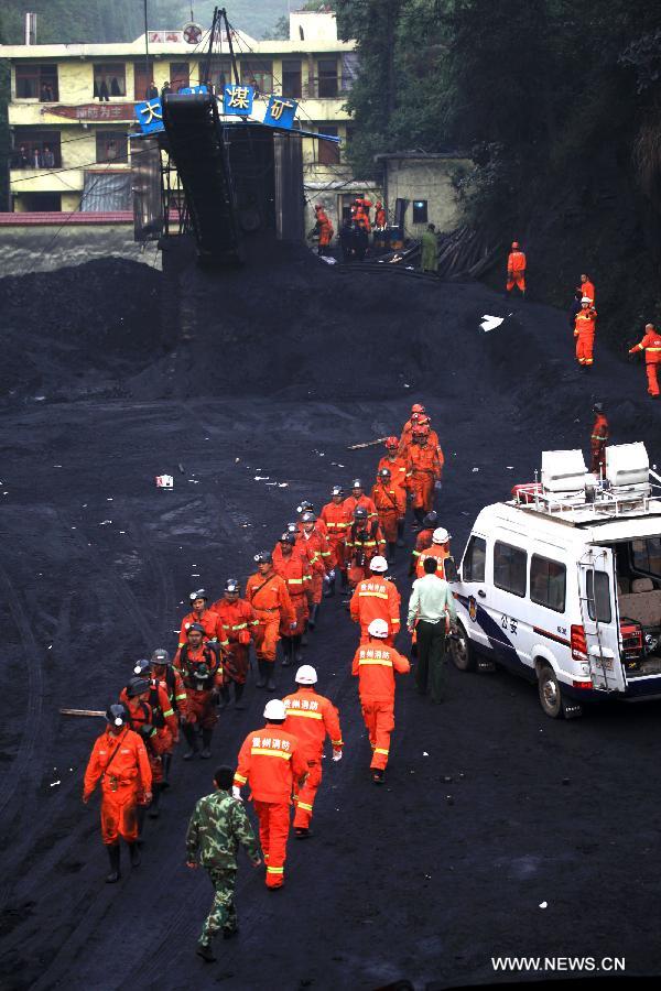 Rescuers work at the Dashan coal mine where a colliery gas explosion occurred in Pingba County, southwest China&apos;s Guizhou Province, May 11, 2013. Twelve people were killed and two others injured in the explosion on the evening of May 10.