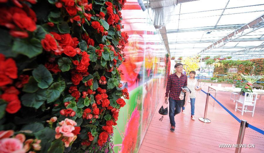 Tourists visit the flower park in the 2013 World Landscape Art Exposition Jinzhou China, in Jinzhou, northeast China's Liaoning Province, May 10, 2013. The exposition kicked off on Friday, attracting more than 300 artists from at home and abroad. (Xinhua/Jiang Bing) 
