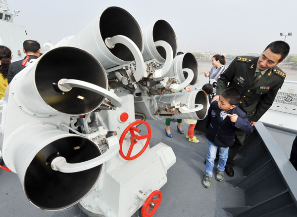 People's Liberation Army officers and civilians visit the PLA navy's missile frigate Yiyang on Saturday during an open day event in Zhoushan, Zhejiang province. Wu Linhong / For China Daily 