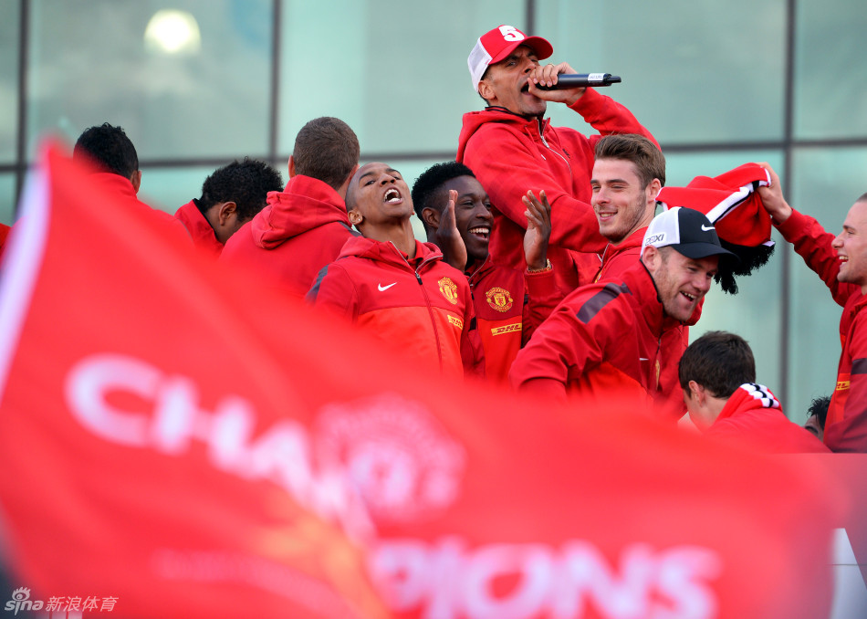Manchester United players celebrate on board the bus outside Old Trafford.
