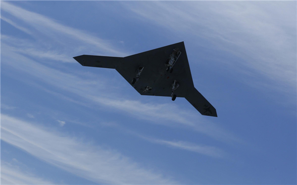 An X-47B pilot-less drone combat aircraft is pictured as it flies over the aircraft carrier, the USS George H. W. Bush, after being launched from the ship in the Atlantic Ocean off the coast of Virginia, May 14, 2013.