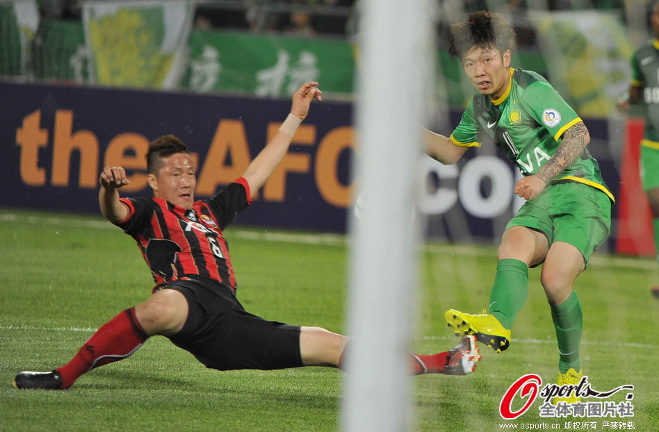 Zhang Xizhe curles his attempt at goal just wide of the target. 