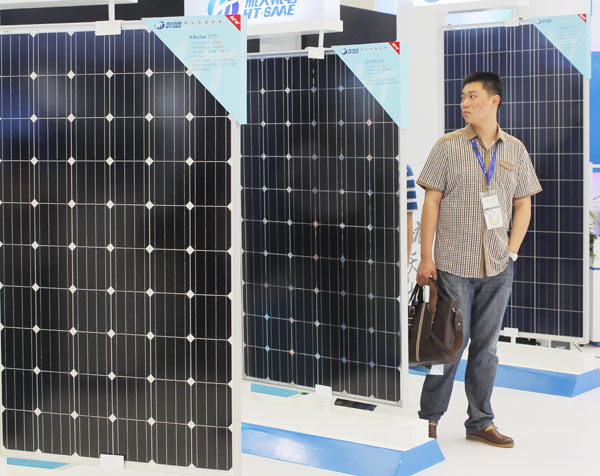 Solar panels on display at a solar and photovoltaic industry show in Shanghai on Tuesday. China has launched anti-dumping and anti-subsidy investigations into solar-grade polysilicon, an ingredient in solar panels, imported from the United States. [China Daily]