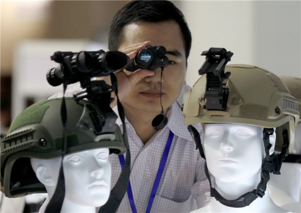 An exhibitor displays a night observation device at the Fifth China International Exhibition and Symposium on Police Equipment and Anti-terrorism Technology and Equipment on Thursday in Beijing. [Photo / China Daily]