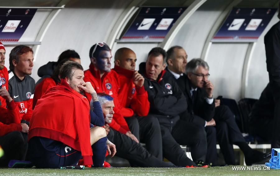 Paris Saint-Germain's English midfielder David Beckham looks pensive sitting on the pitch after he is substituted during a French League 1 football match between Paris St Germain and Brest at Parc des Princes stadium in Paris on May 18, 2013. [Wang Lili/Xinhua]