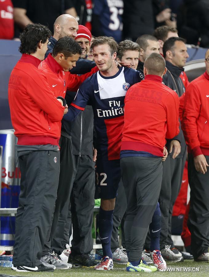 Paris Saint-Germain's English midfielder David Beckham hugs his teammates after he is substituted during a French League 1 football match between Paris St Germain and Brest at Parc des Princes stadium in Paris on May 18, 2013. [Wang Lili/Xinhua]