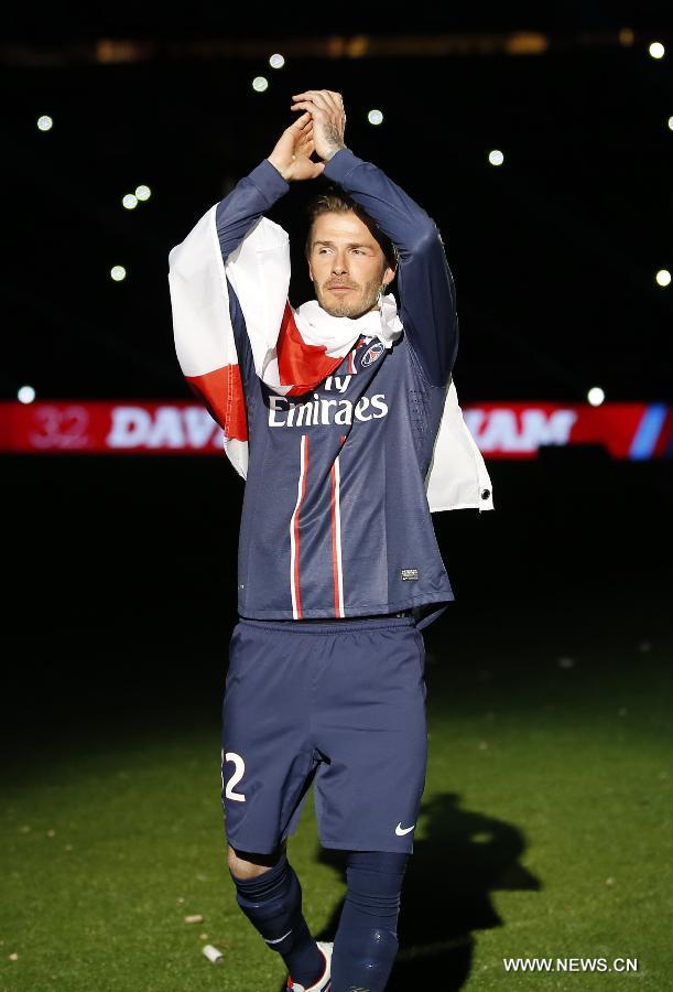 Paris Saint-Germain's English midfielder David Beckham waves to the crowd during the celebration ceremony for winning the French League 1 title after the League 1 football match between Paris St Germain and Brest at Parc des Princes stadium in Paris on May 18, 2013. [Wang Lili/Xinhua]