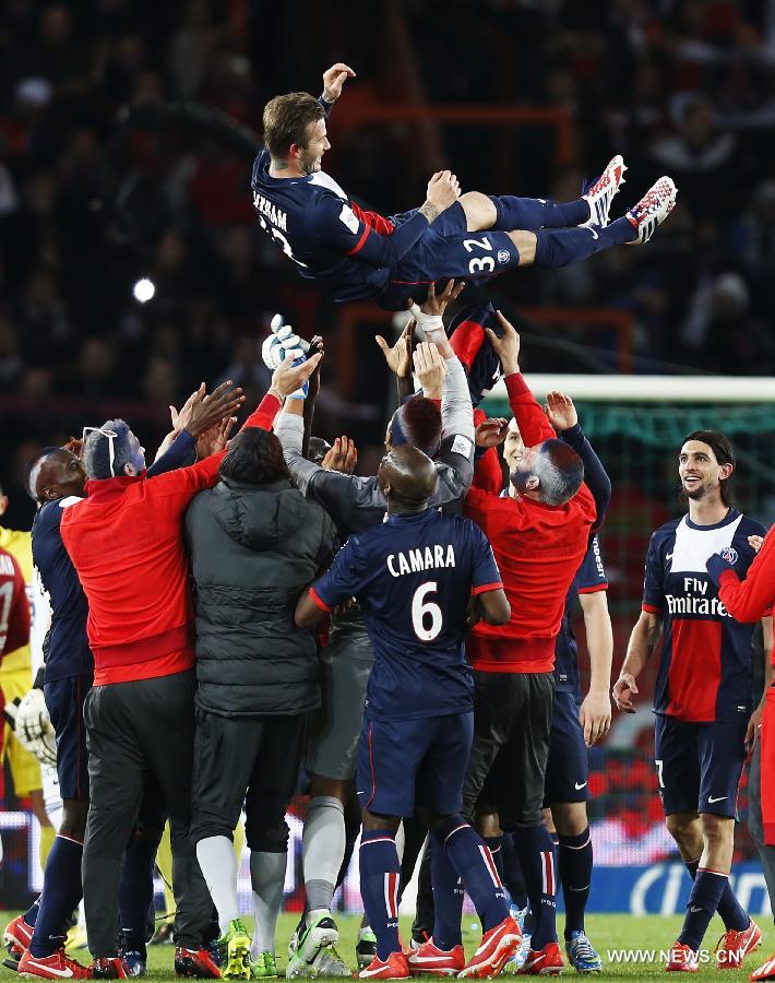 Paris Saint-Germain's English midfielder David Beckham is tossed by teammates after a French League 1 football match between Paris St Germain and Brest at Parc des Princes stadium in Paris on May 18, 2013. Saint-Germain won 3-1. [Wang Lili/Xinhua]