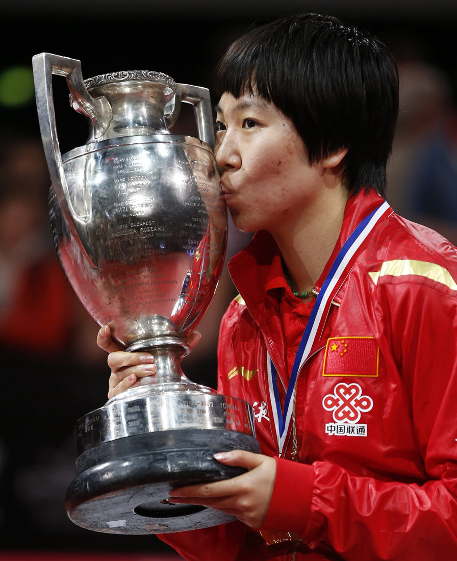 Li Xiaoxia kisses the trophy after winning the women's singles final at the World Table Tennis Championships.