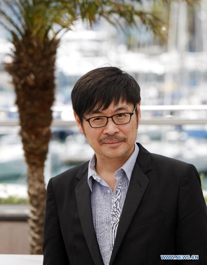 Chinese Hong Kong screenwriter Ka-Fai Wai poses during the photocall for Hong Kong film 'Blind Detective' at the 66th Cannes Film Festival in Cannes, southern France, on May 20, 2013. The film 'Blind Detective' is presented in Midnight Projections at the film festival. [Zhou Lei/Xinhua]
