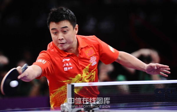 Wang Hao returns a shot to Zhang Jike in the final.