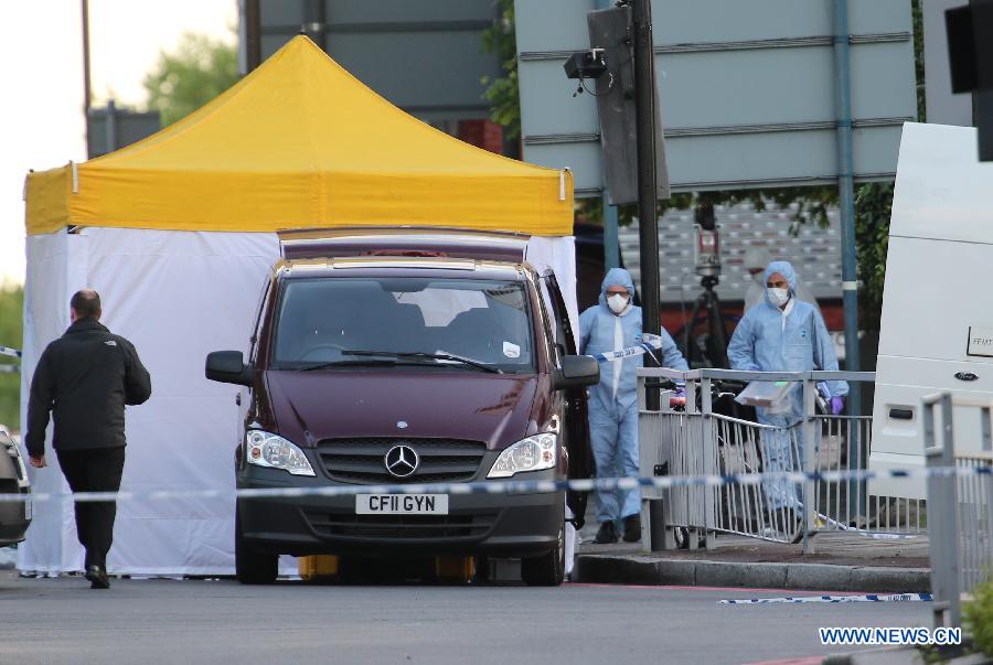 Police forensic officers investigate a crime scene in Woolwich, southeast London May 22, 2013. 