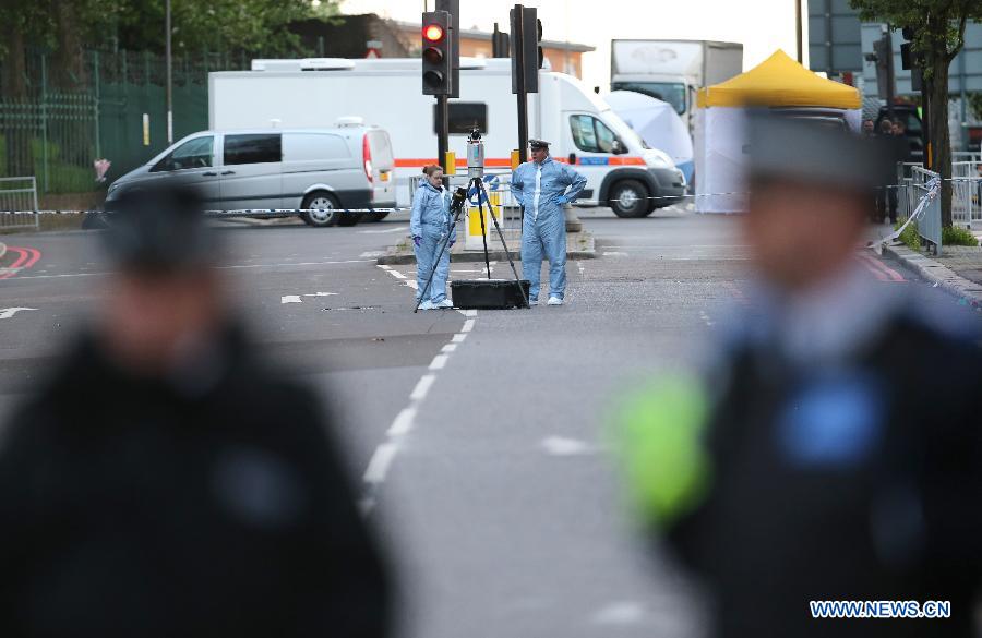 Police forensic officers investigate a crime scene in Woolwich, southeast London May 22, 2013. 