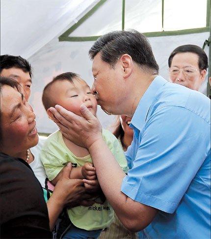 President Xi Jinping kisses a boy at a tent set up for survivors of the 7.0-magnitude earthquake that hit Lushan County in Sichuan Province on April 20. Xi visited people in tents, inquired about the health of quake-hit patients, and spoke to primary school students in Lushan.