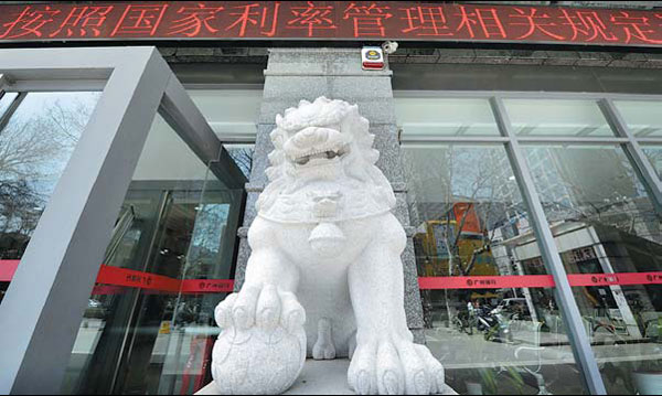 A lion sculpture in front of a bank, a common scene in China. Many bankers believe the animal is a 'patron saint' of their business and customers. But many in Wenzhou, if their business goes awry or is on the verge of bankruptcy, may turn to special trustees for help because they believe trustees provide a butler-like service, helping them to work out all kinds of detailed restructuring measures to reorganize daily operations and sketch out long-term future plans step by step. [China Daily]
