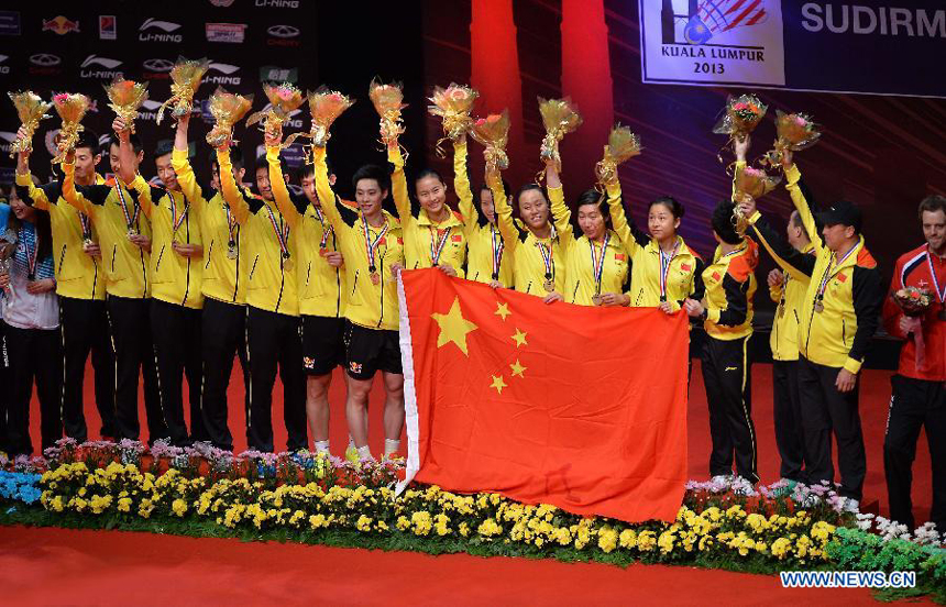 Players of China celebrate during the awarding ceremony after the final match against South Korea at the Sudirman Cup World Team Badminton Championships in Kuala Lumpur, Malaysia, on May 26, 2013. Team China won the champion with 3-0.