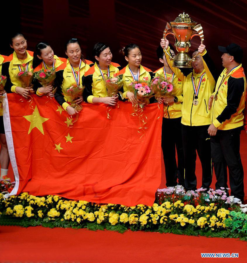 Players of China celebrate during the awarding ceremony after the final match against South Korea at the Sudirman Cup World Team Badminton Championships in Kuala Lumpur, Malaysia, on May 26, 2013. Team China won the champion with 3-0.