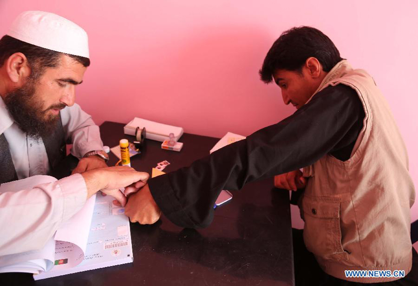 An Afghan man registers for the voter card at a voter registration center in Ghazni province, eastern Afghanistan, on May 26, 2013. The voter registration process for the general elections scheduled for April 5, 2014 started in Afghanistan on Sunday, the country&apos;s election commission said in a press release.