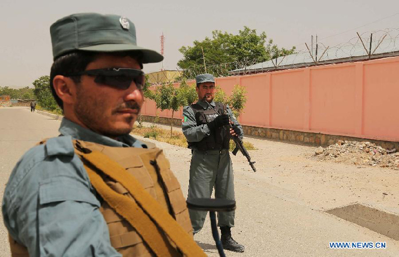 Afghan policemen stand guard outside a voter registration center in Ghazni province, eastern Afghanistan, on May 26, 2013. The voter registration process for the general elections scheduled for April 5, 2014 started in Afghanistan on Sunday, the country&apos;s election commission said in a press release.