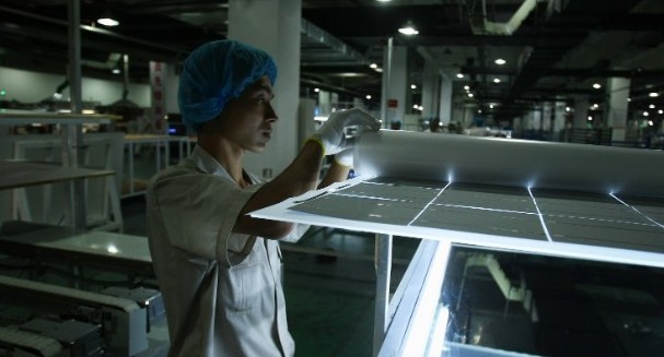 A worker at a solar panel assembly line in China. [File photo]