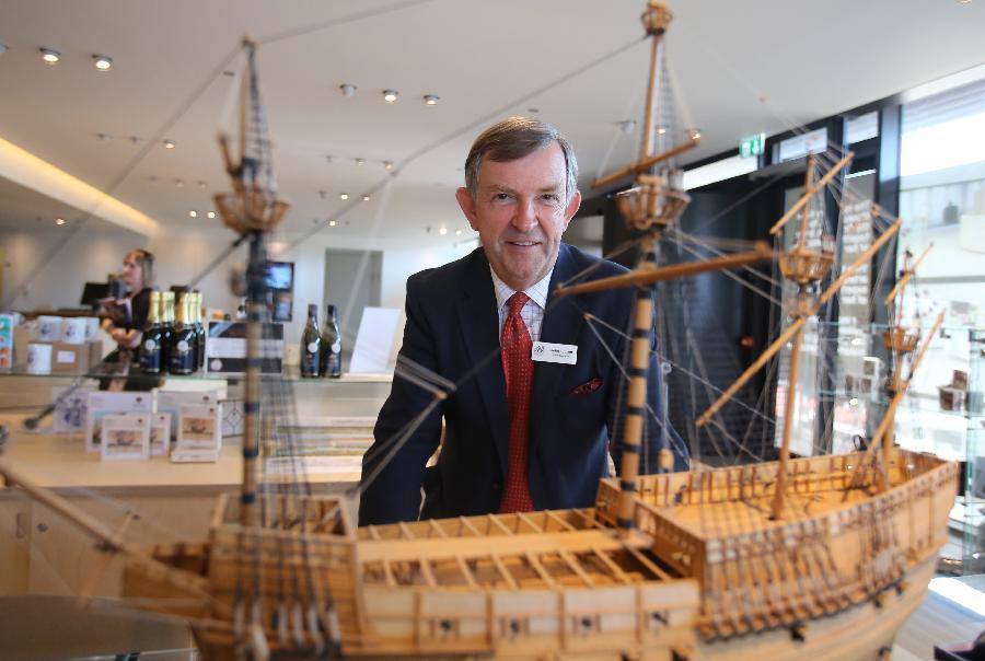 Rear-Admiral John Lippiett, chief executive of the Mary Rose Trust, poses with a replica of the Mary Rose at Mary Rose museum in south England&apos;s Portsmouth, April 25, 2013. The Mary Rose museum opened here on May 31, 2013. The new museum, at the historic dockyard in Portsmouth and in the shape of the bow of a black ship, was aimed at taking visitors to a journey through 500 years, so as to learn the story of the Mary Rose, one of the largest and most famous ships in the English navy. (Xinhua/Yin Gang)