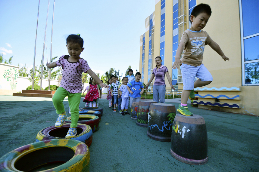 Children enjoy outdoor games in a kindergarten of Miyun County in suburb Beijing on May 29. Various kinds of activities are held nationwide to celebrate the International Children’s Day which falls on June 1. 