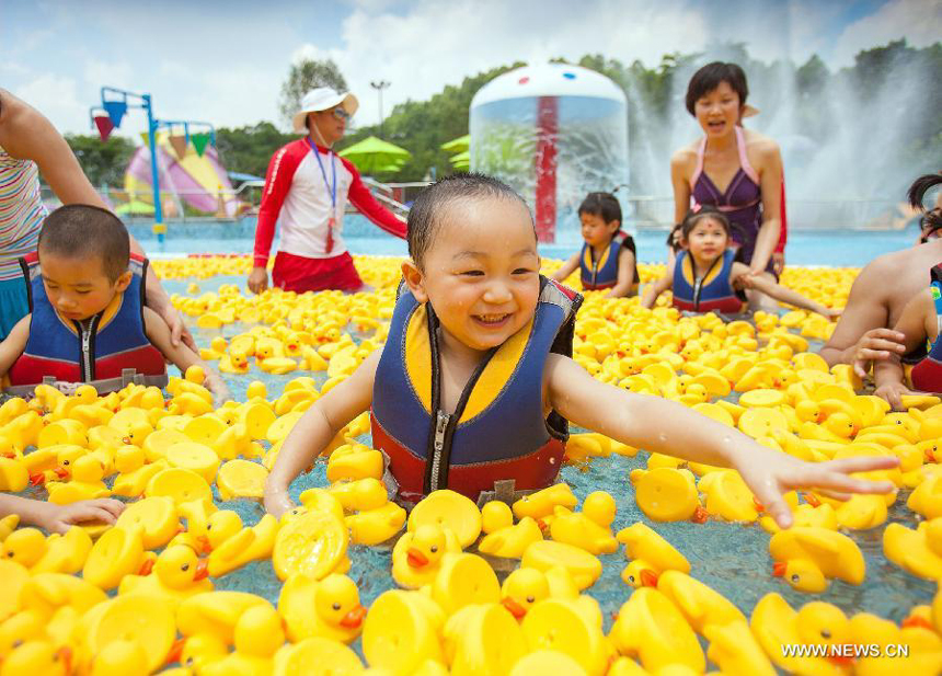 Children play with toys in a pool in Guangzhou, capital of south China's Guangdong Province, May 31, 2013. Various activities are held across China to celebrate the International Children's Day.