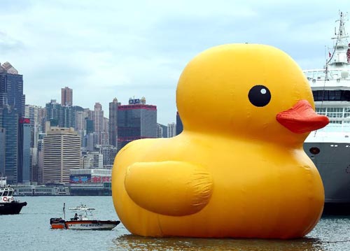 A huge rubber duck floats on the waters at the Victoria Harbor in Hong Kong, south China, May 2, 2013. The largest rubber duck was created by Dutch artist Florentijn Hofman, with 18 meters of length, 15 meters of width and height. The duck has visited 12 cities since 2007. [Xinhua/Li Peng]