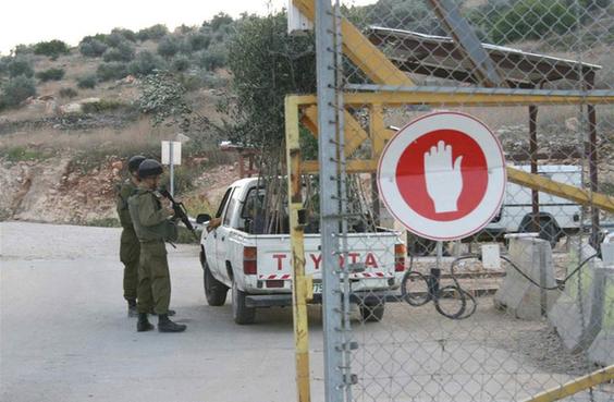 Israeli soldiers inspect a vehicle entering the village of Azzun Atma through the West Bank Barrier. [Tom Spender/IRIN] 