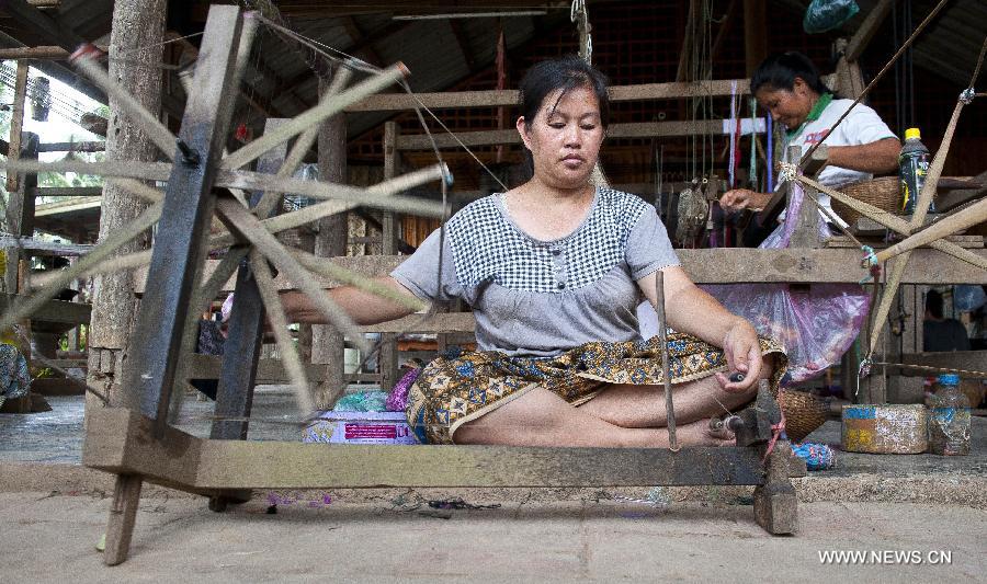 Women weave in traditional ways in Luang Prabang, Laos, June 3, 2013. Luang Prabang, the capital of Luang Prabang Province, is a small peaceful city in northern Laos, at the confluence of the Nam Khan river and Mekong River. With a more than 1,000 years history, Luang Prabang was listed by United Nations Educational, Scientific and Cultural Organization (UNESCO) as a world heritage in 1995. (Xinhua/Chen Duo) 