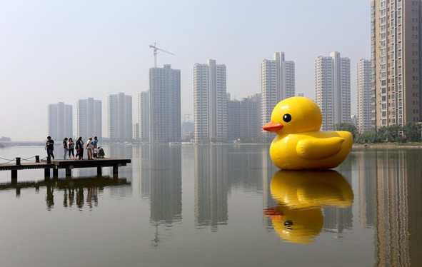 Visitors to Tianjin , take photos of an inflatable rubber duck.