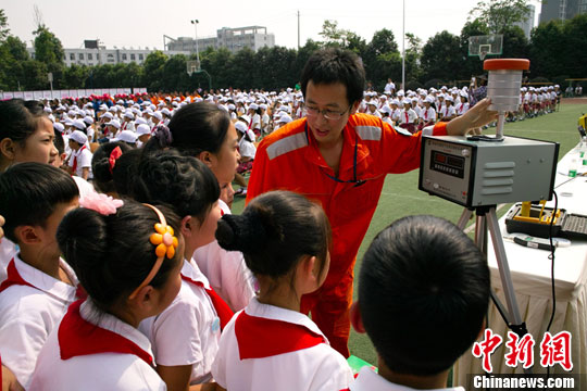 An environmental protection workers show air pollution surveying instruments to students in a primary school in Chengdu, Sichuan Province, on June 3. World Environment Day is celebrated every year on 5 June to raise global awareness of the need to take positive environmental action. It is run by the United Nations Environment Program (UNEP). 