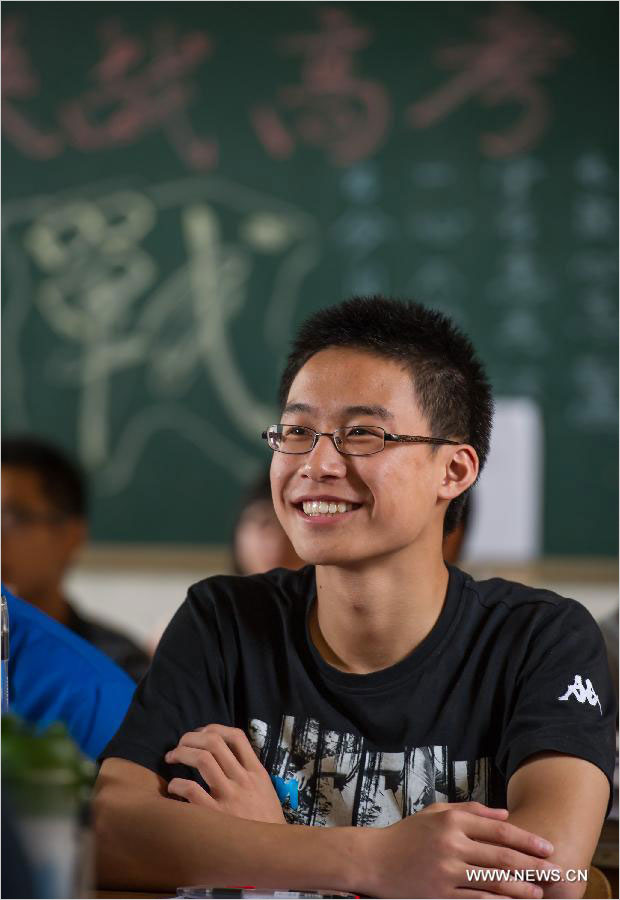 A student smiles as attending the last lesson at the Yucai Middle School in Chongqing, southwest China, June 4, 2013. Three days later, the high school graduates will take part in the national college entrance exam, which is set for June 7 and 8.