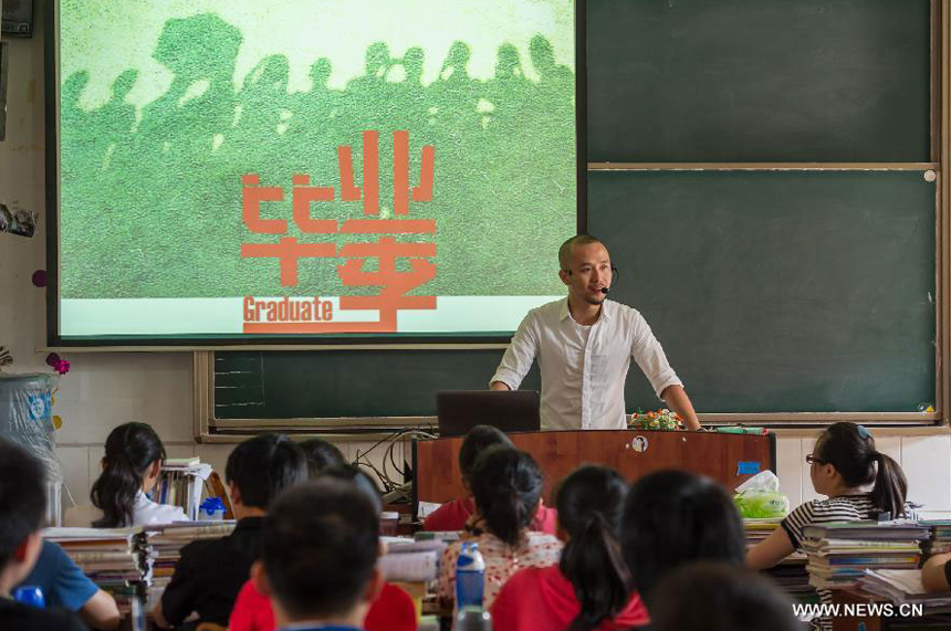 Teacher He Xueyi gives lesson for his students who are about to graduate at the Yucai Middle School in Chongqing, southwest China, June 4, 2013. Three days later, the high school graduates will take part in the national college entrance exam, which is set for June 7 and 8.