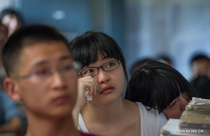 A student cries on the occasion of her graduation at the Yucai Middle School in Chongqing, southwest China, June 4, 2013. Three days later, the high school graduates will take part in the national college entrance exam, which is set for June 7 and 8.