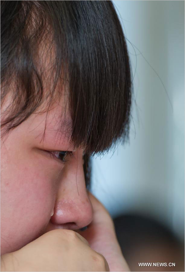 A student cries on the occasion of her graduation at the Yucai Middle School in Chongqing, southwest China, June 4, 2013. Three days later, the high school graduates will take part in the national college entrance exam, which is set for June 7 and 8.