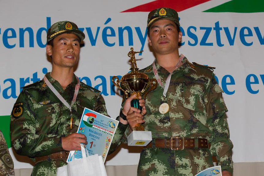 Wang Zhanjun (L) and Zhang Yong of China pose with their trophy during the awarding ceremony at the 12th Police and Military Sniper World Cup in Budapest, Hungary, on June 4, 2013. Wang and Zhang won the gold medal of the Team Military sniper competition of the event. 