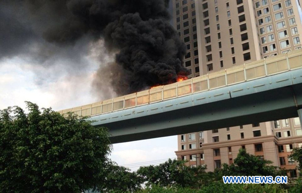 Photo taken by mobile phone on June 7, 2013 shows the bus on fire on an elevated track in Xiamen, southeast China&apos;s Fujian Province. At least 48 people died and more than 30 others were injured after the bus in the city&apos;s BRT (bus rapid transit) service burst into flames at about 6:30 p.m. on Friday. [Photo/Xinhua]