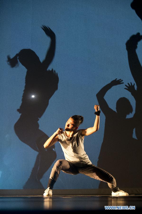 A dancer from Dragon Style Kung Fu Performance Troupe performs in the Kungfu Dance &apos;The Door&apos; at the Peking University Hall in Beijing, capital of China, June 10, 2013. (Xinhua/Zhao Bing)