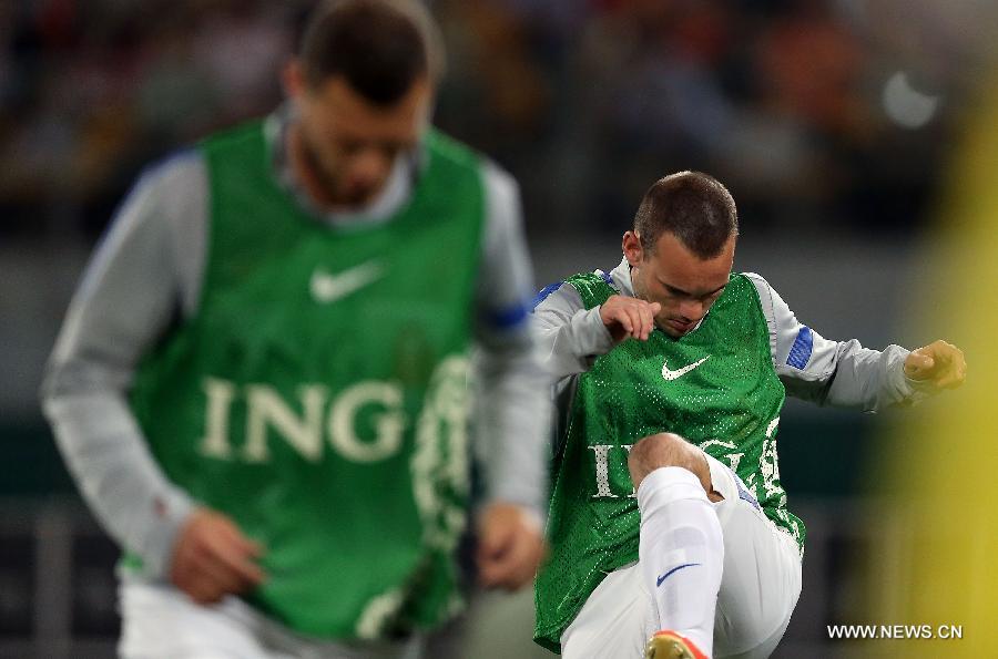 Wesley Sneijder (R) of the Netherlands warms up prior to the international friendly soccer match against China at the Workers Stadium in Beijing, capital of China, June 11, 2013. (Xinhua/Li Ming)