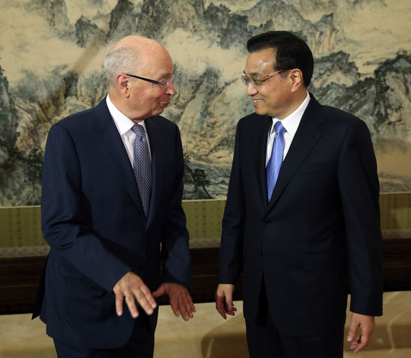 Premier Li Keqiang meets Klaus Schwab, executive chairman of the World Economic Forum, in Beijing on Friday. [China Daily]