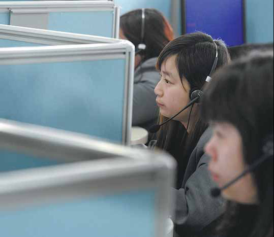 Staff at a business call center in Nanjing, capital city of Jiangsu province, answering inquiries raised by customers from inside and outside the country. Business outsourcing has allowed companies to split services into components that can be subcontracted and performed in the most efficient and cost-effective way. [China Daily]