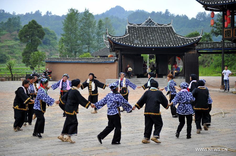 Photo taken on June 16, 2013 shows the wooden Diaojiaolou, or stilted houses in Shiyanping Village, Wangjiaping Township of Zhangjiajie City in central China's Hunan Province. 